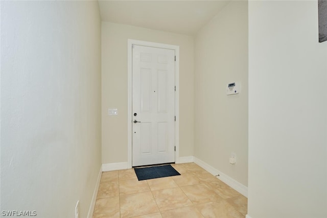 entrance foyer with baseboards and light tile patterned floors