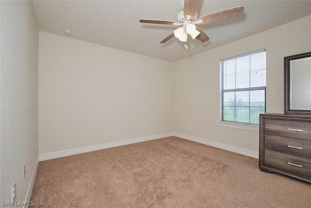 carpeted empty room featuring ceiling fan