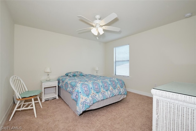 bedroom featuring light carpet, ceiling fan, and baseboards