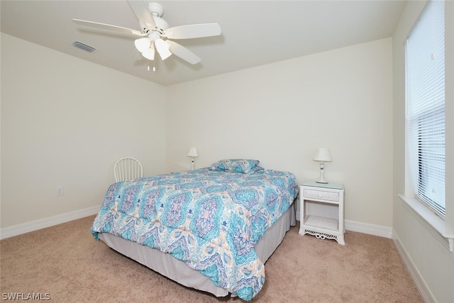 bedroom featuring light carpet, visible vents, and baseboards