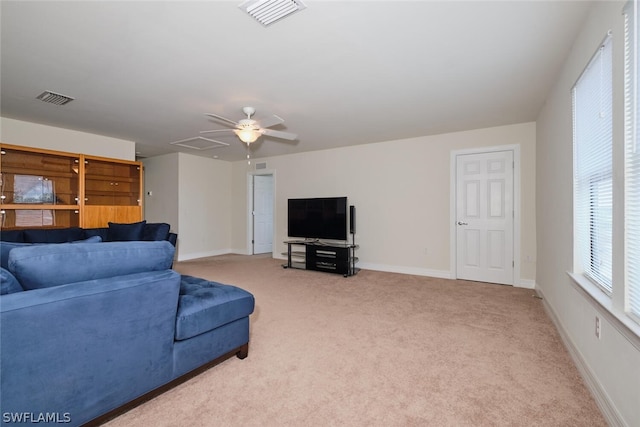 carpeted living room with ceiling fan