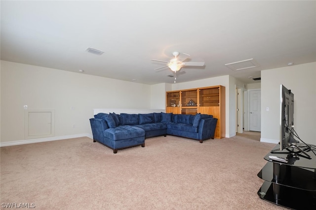 carpeted living room with ceiling fan