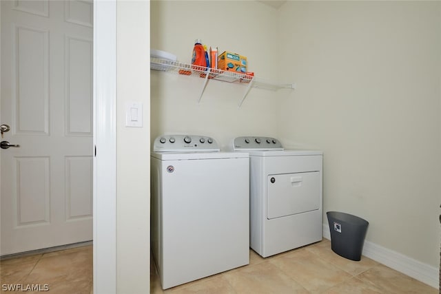 laundry room featuring light tile patterned floors and independent washer and dryer