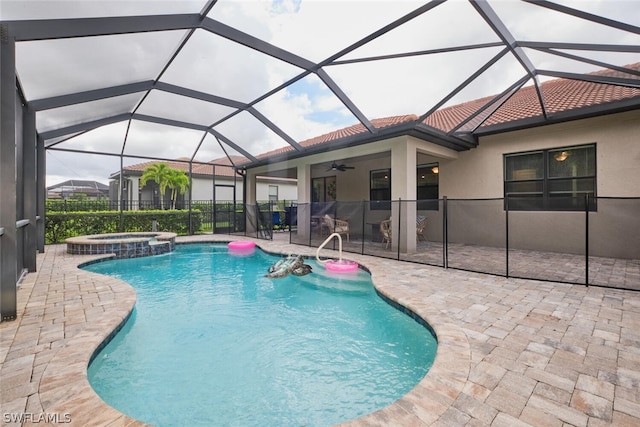 view of swimming pool featuring ceiling fan, a patio area, a lanai, and an in ground hot tub