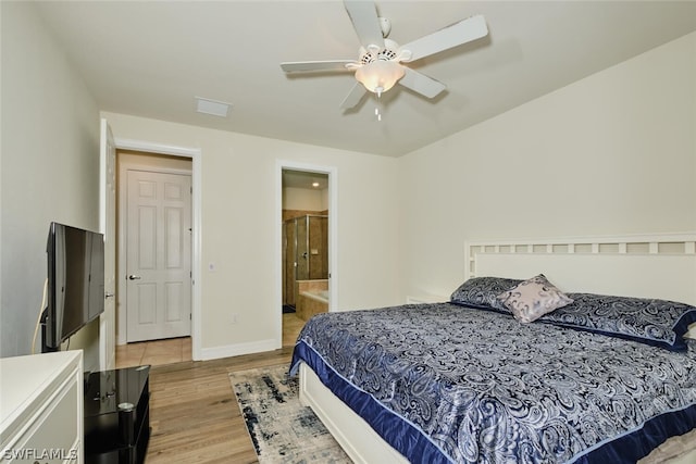 bedroom with ensuite bathroom, ceiling fan, and light hardwood / wood-style flooring