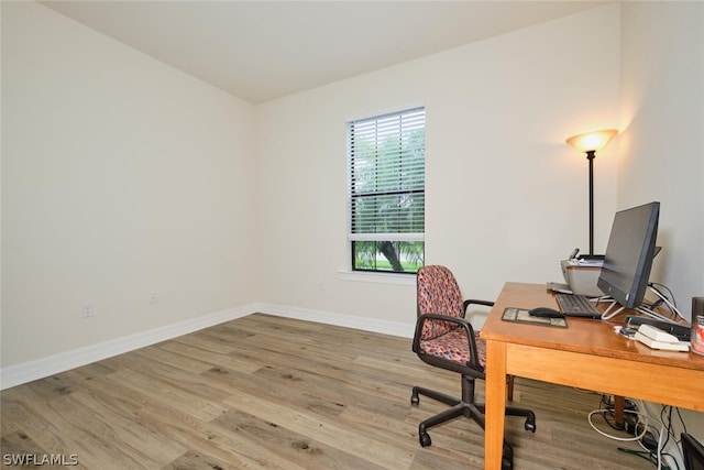 office with light hardwood / wood-style flooring