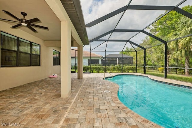 outdoor pool with a patio area and glass enclosure