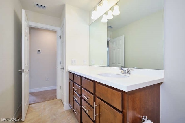 bathroom featuring tile patterned flooring, visible vents, vanity, and baseboards