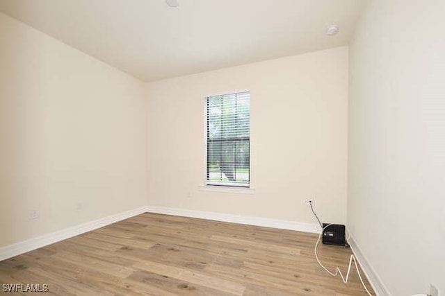 empty room featuring light wood-style floors and baseboards