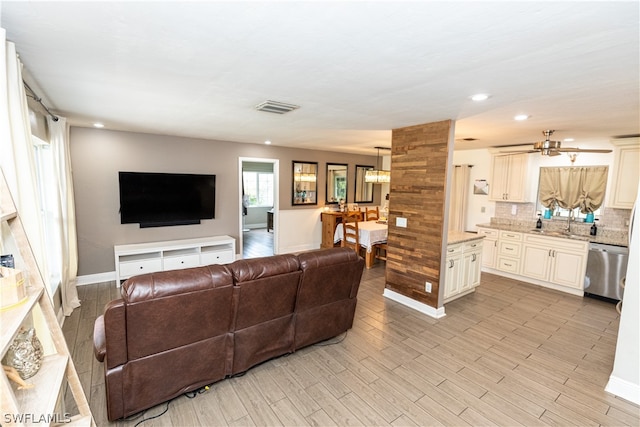 living room featuring ceiling fan and sink