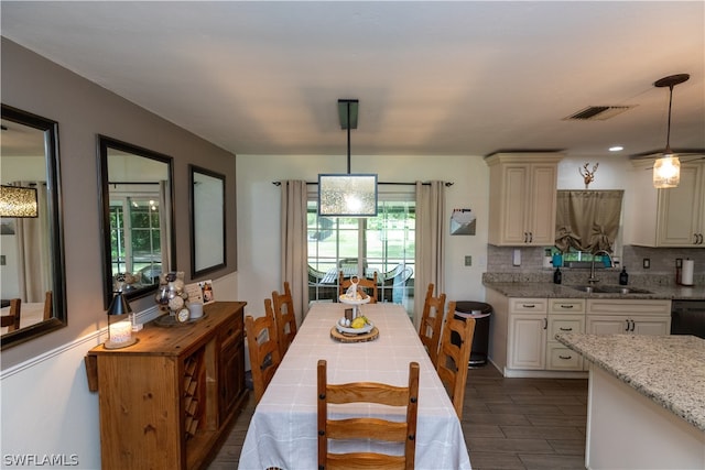 dining area featuring sink and plenty of natural light