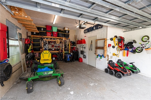 garage with a workshop area and a garage door opener