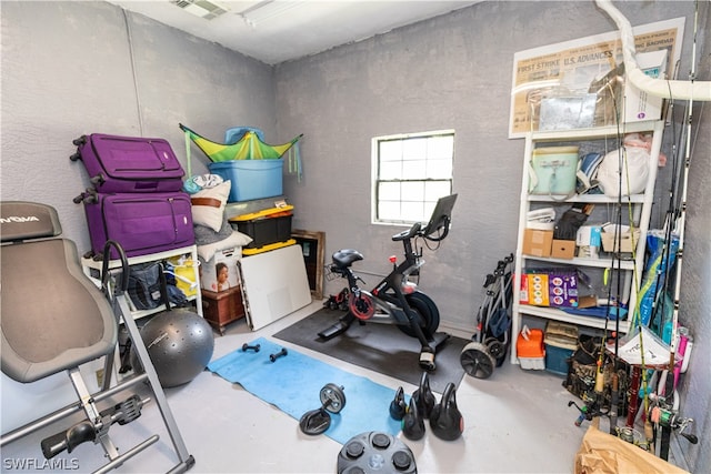 exercise room featuring concrete flooring