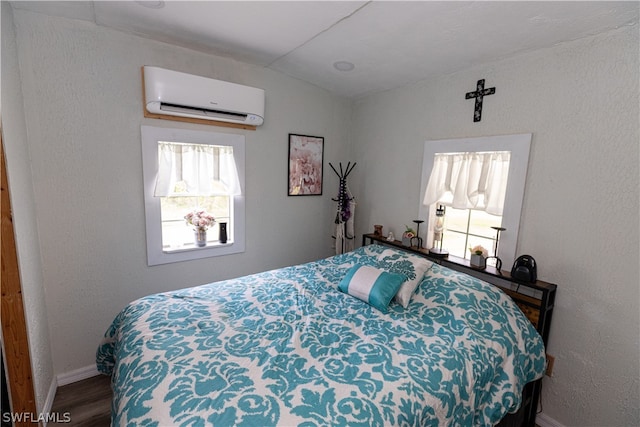 bedroom featuring lofted ceiling, wood-type flooring, and a wall mounted air conditioner