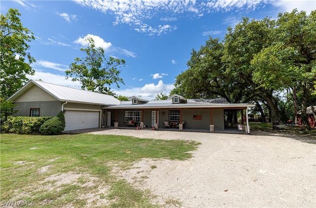 single story home with a garage and a front lawn