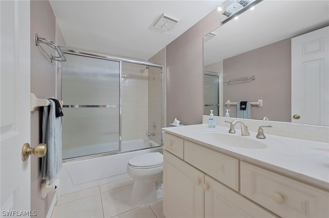 full bathroom with vanity, tile patterned floors, shower / bath combination with glass door, and toilet