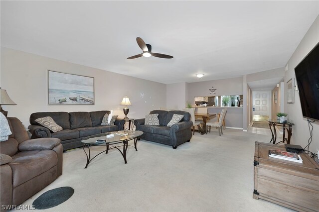 living room featuring carpet floors and ceiling fan