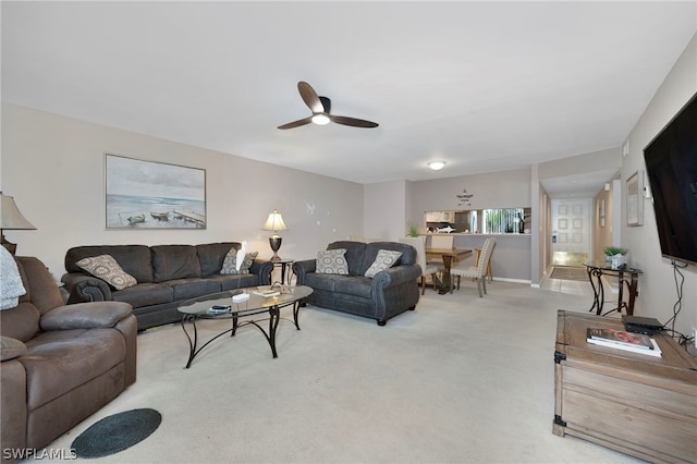 living room with ceiling fan and carpet flooring