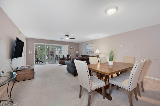 dining room featuring light colored carpet and ceiling fan