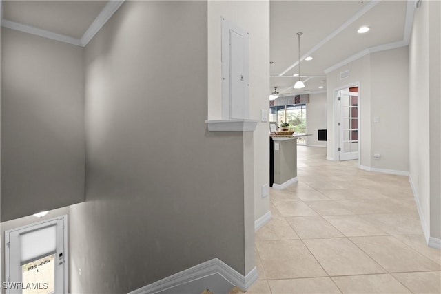 corridor featuring crown molding and light tile patterned floors