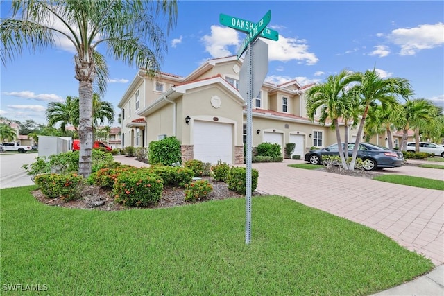 view of front of house with a garage and a front lawn