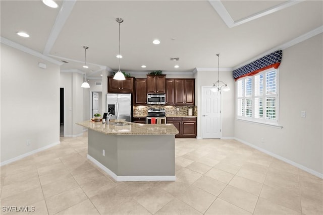 kitchen featuring decorative backsplash, light stone countertops, ornamental molding, an island with sink, and stainless steel appliances