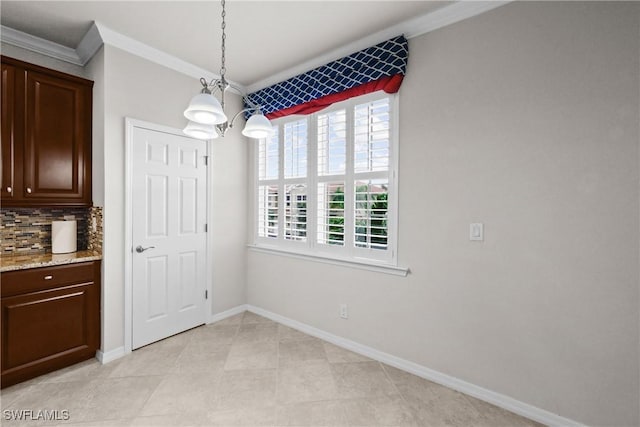 dining area with crown molding and a notable chandelier