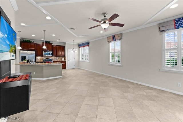 kitchen featuring decorative backsplash, appliances with stainless steel finishes, a center island, and ornamental molding