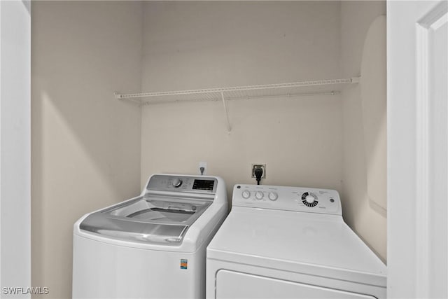 washroom featuring washer and clothes dryer