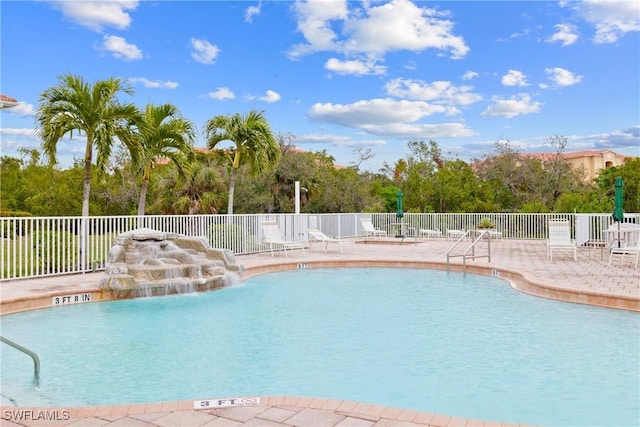 view of swimming pool featuring a patio and pool water feature