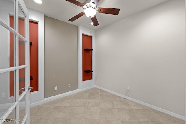 empty room with ceiling fan and french doors