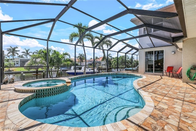 view of pool featuring glass enclosure, an in ground hot tub, and a patio