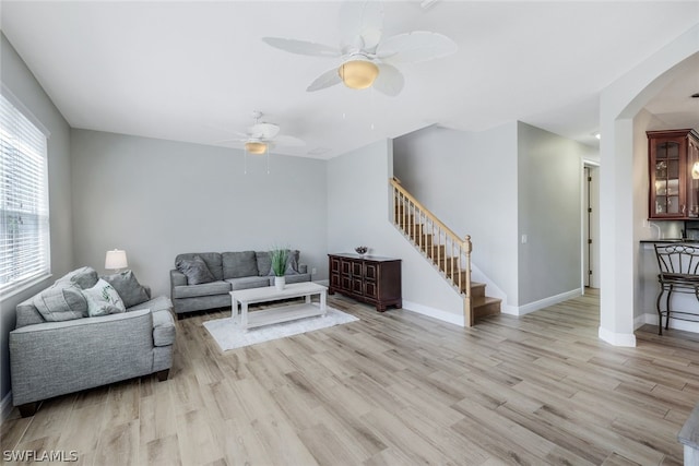 living room with light wood-type flooring and ceiling fan