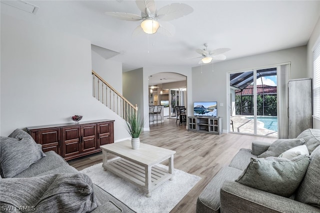 living room with ceiling fan and light wood-type flooring