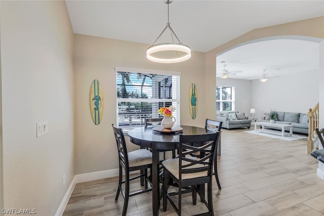 dining space with ceiling fan and lofted ceiling