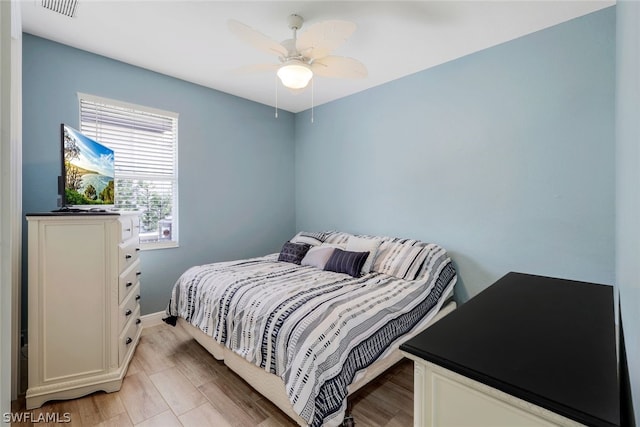 bedroom with ceiling fan and light hardwood / wood-style flooring