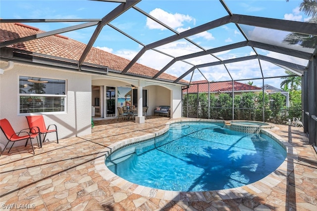 view of pool with an in ground hot tub, a patio, and a lanai