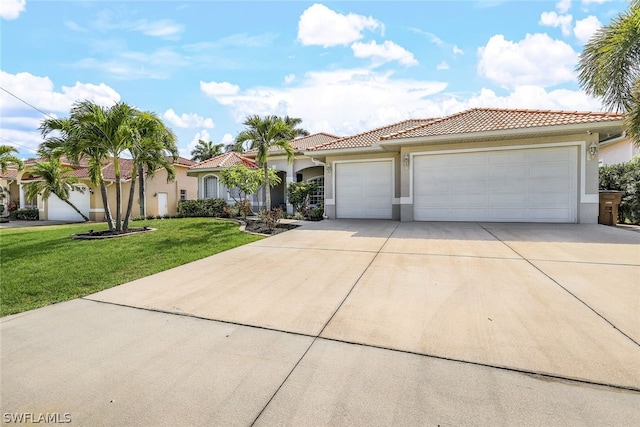 mediterranean / spanish house with a garage and a front lawn