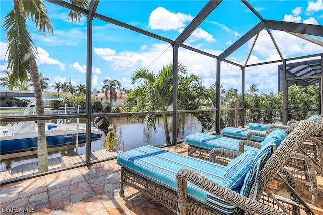 view of patio / terrace with glass enclosure, a water view, and a boat dock