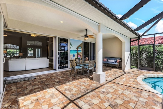 unfurnished sunroom with ceiling fan