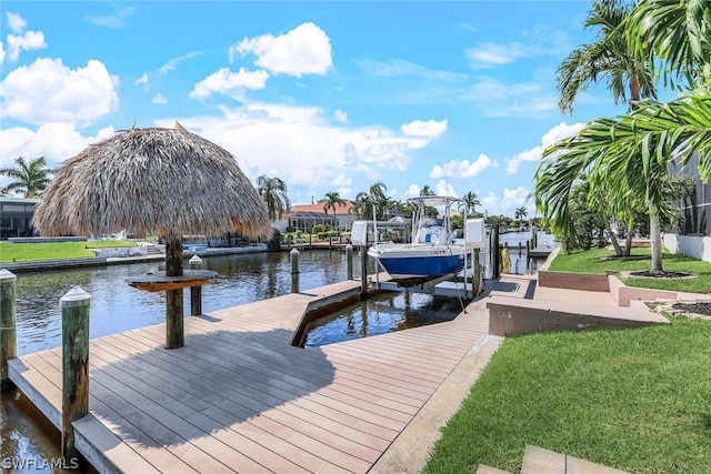 dock area featuring a lawn and a water view