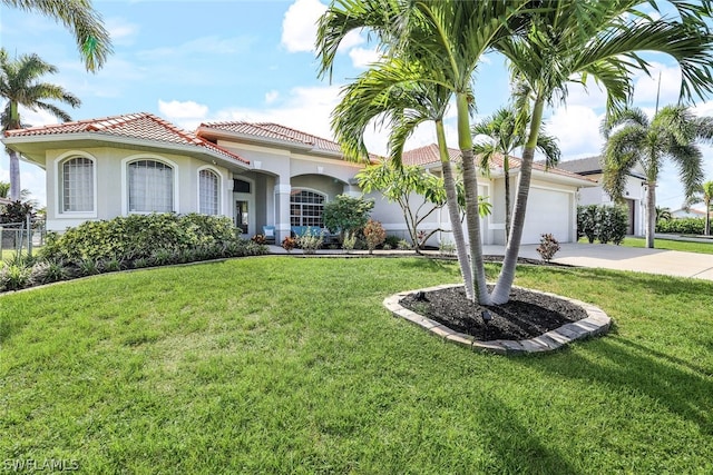 mediterranean / spanish home with a front yard and a garage