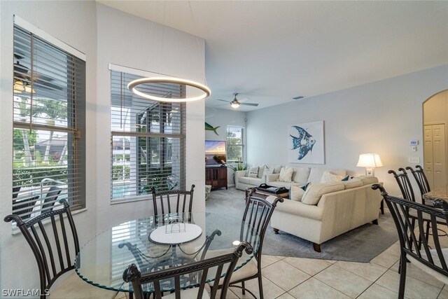 tiled dining space with ceiling fan