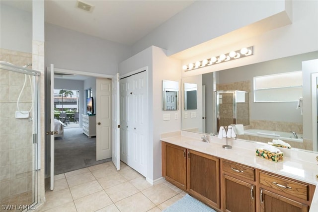 bathroom with tile patterned flooring, vanity, and independent shower and bath