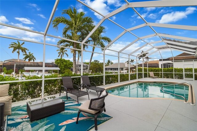 view of swimming pool with a lanai and a patio