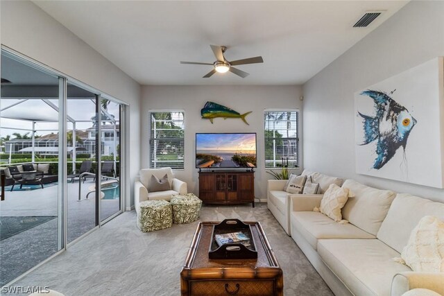 living room with ceiling fan and carpet floors