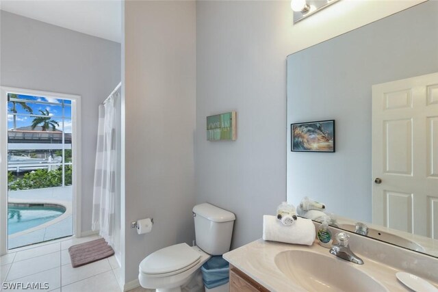 bathroom featuring tile patterned floors, vanity, and toilet