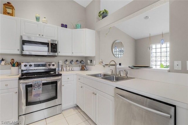 kitchen with appliances with stainless steel finishes, white cabinetry, and sink