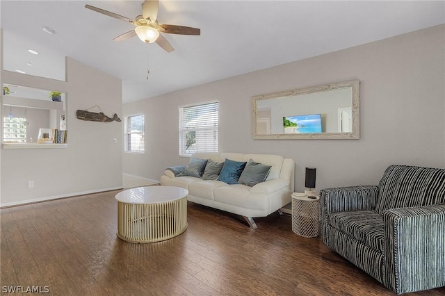 living room featuring ceiling fan and dark hardwood / wood-style floors