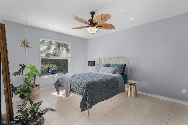 tiled bedroom featuring ceiling fan